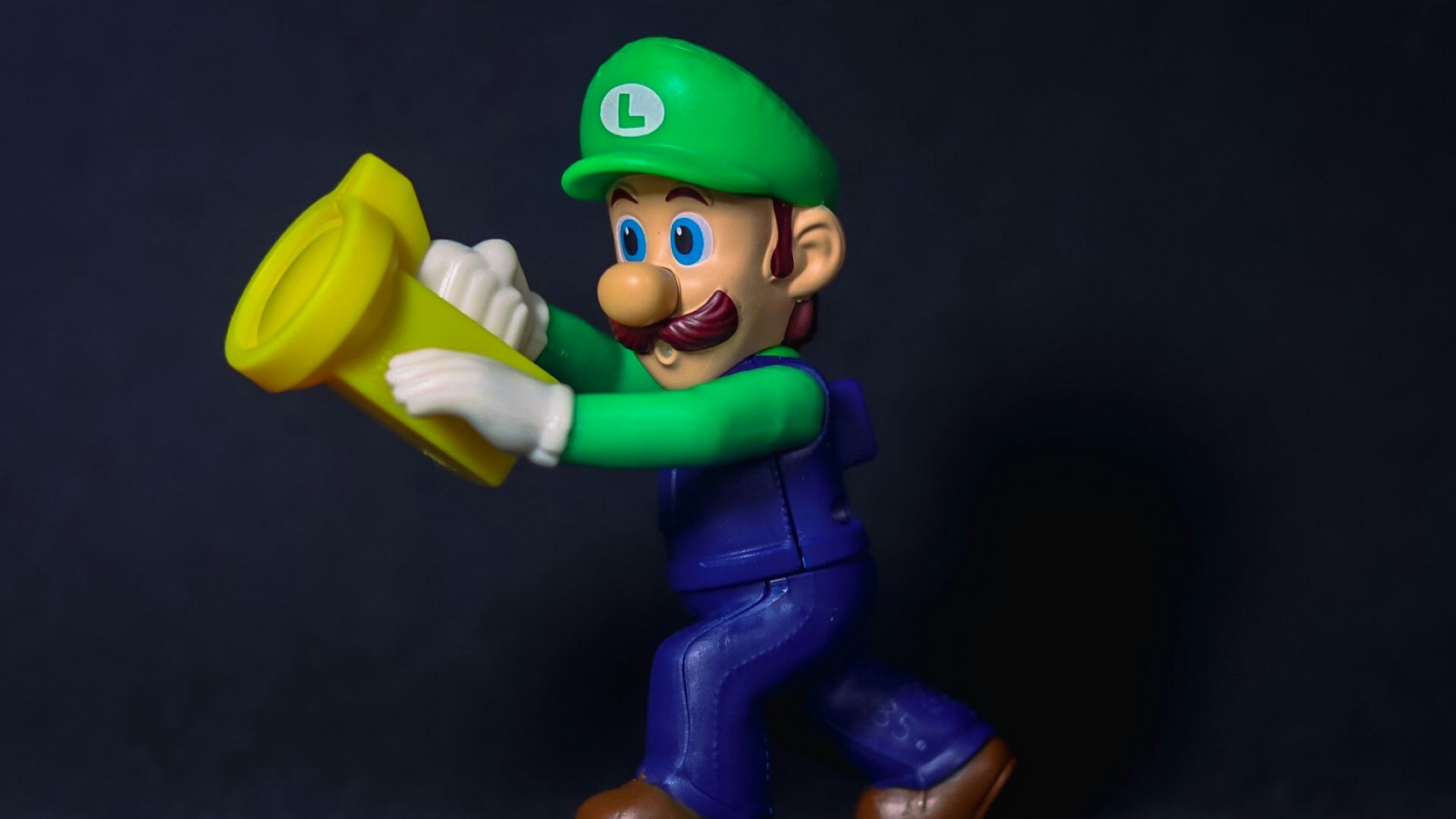 a figurine of a man holding a yellow frisbee