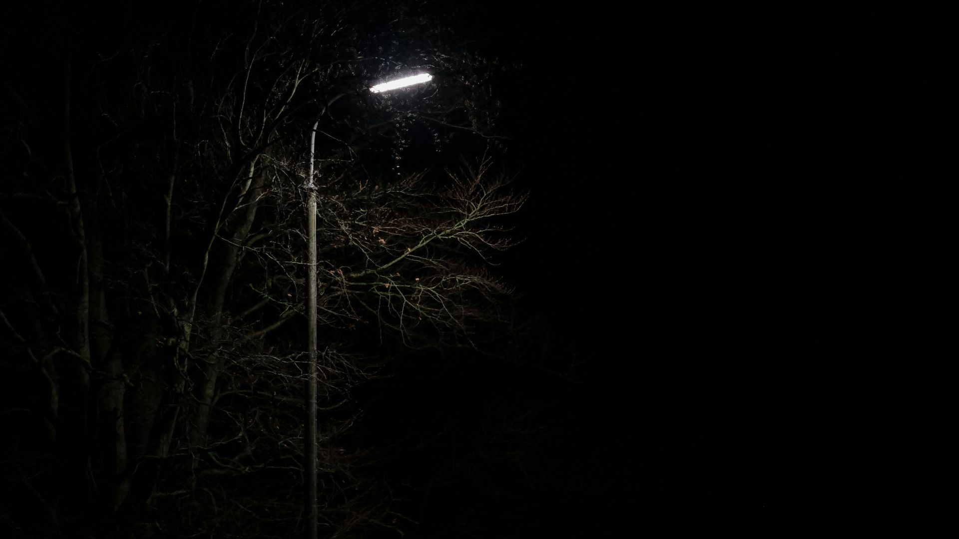 view of empty road under light post