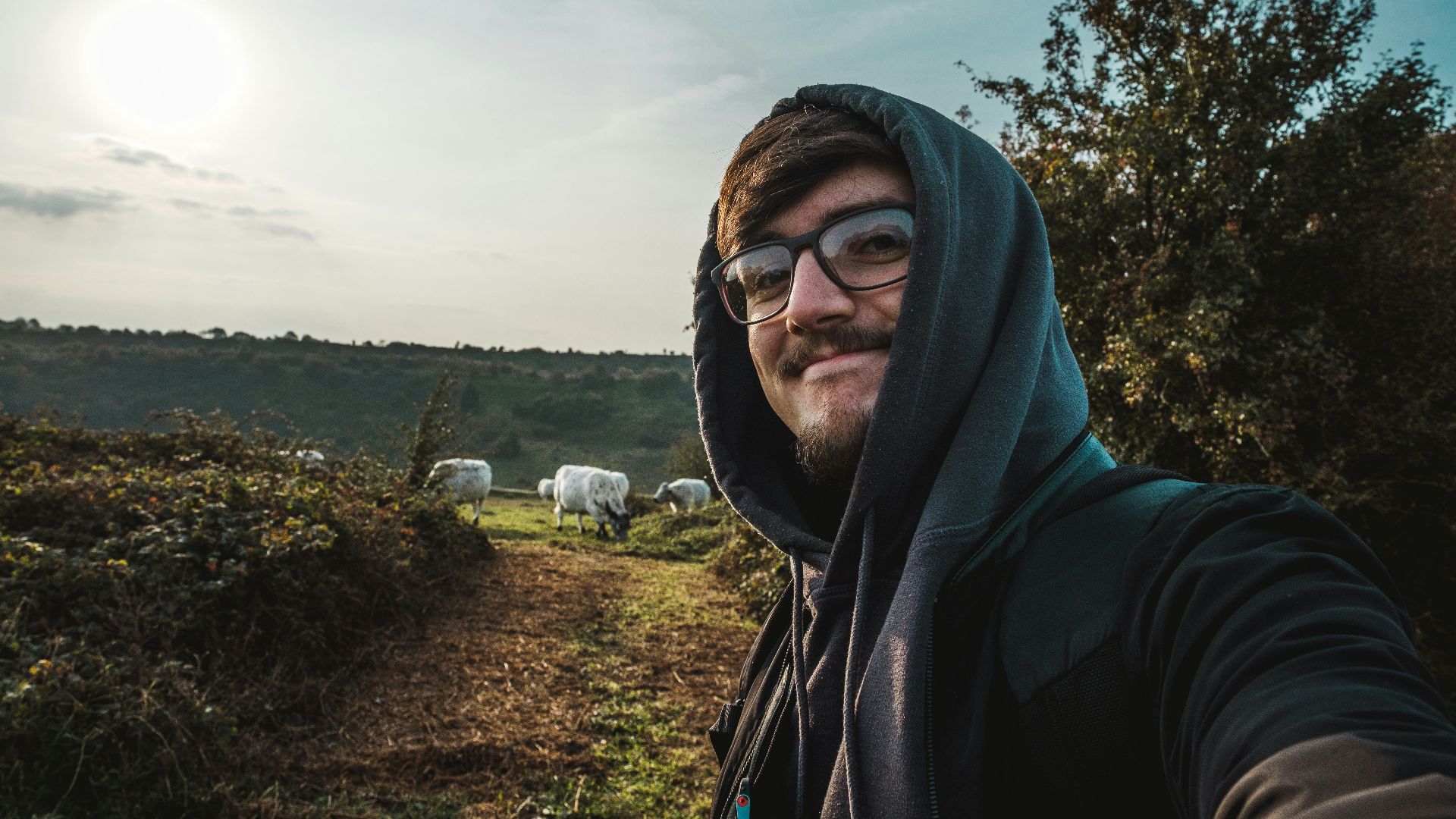 man in black hoodie wearing black framed eyeglasses