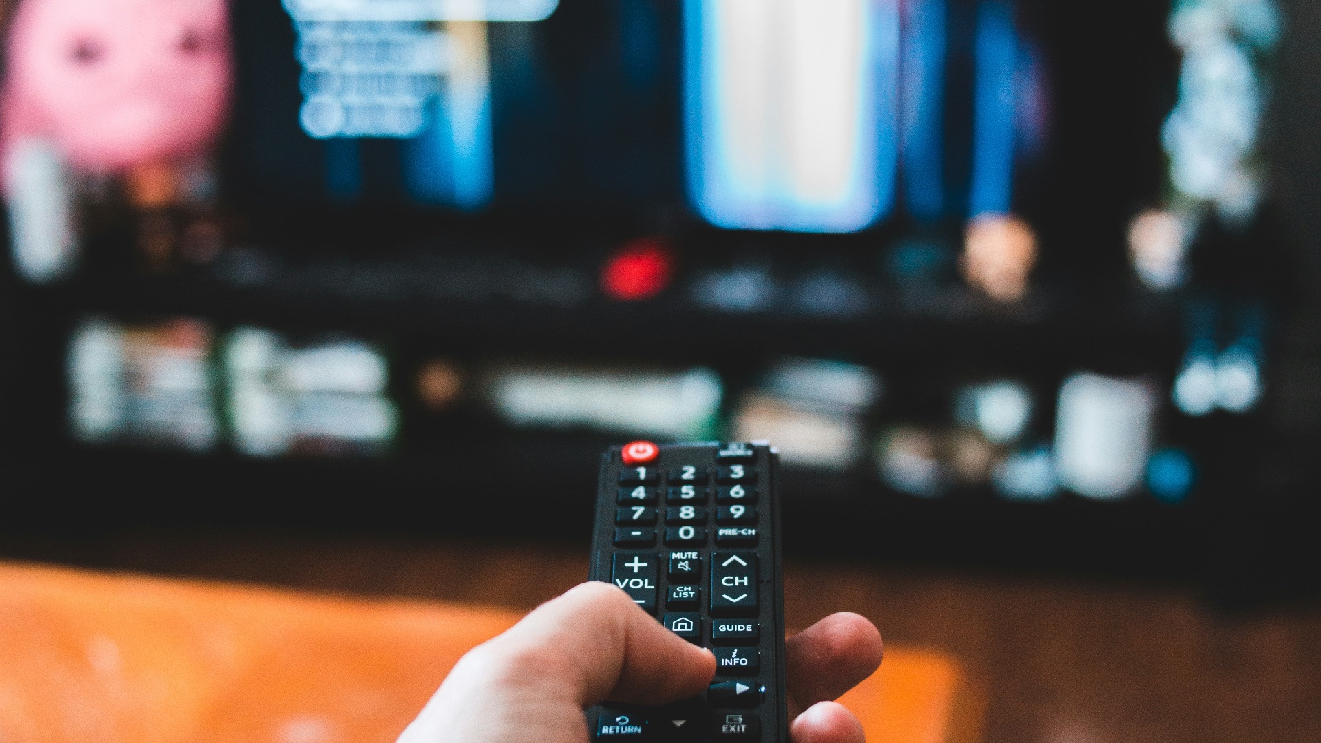 person holding black remote control