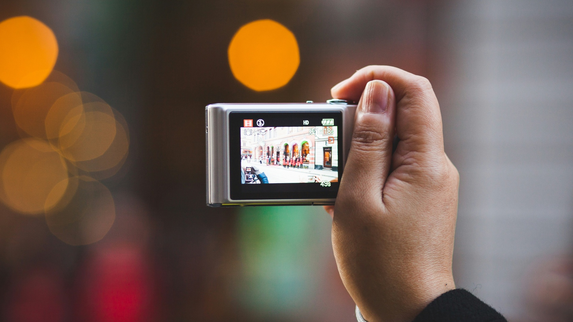 person holding digital camera