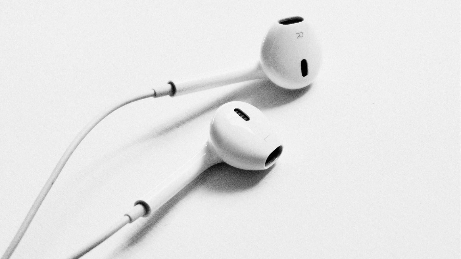 apple earpods on white surface