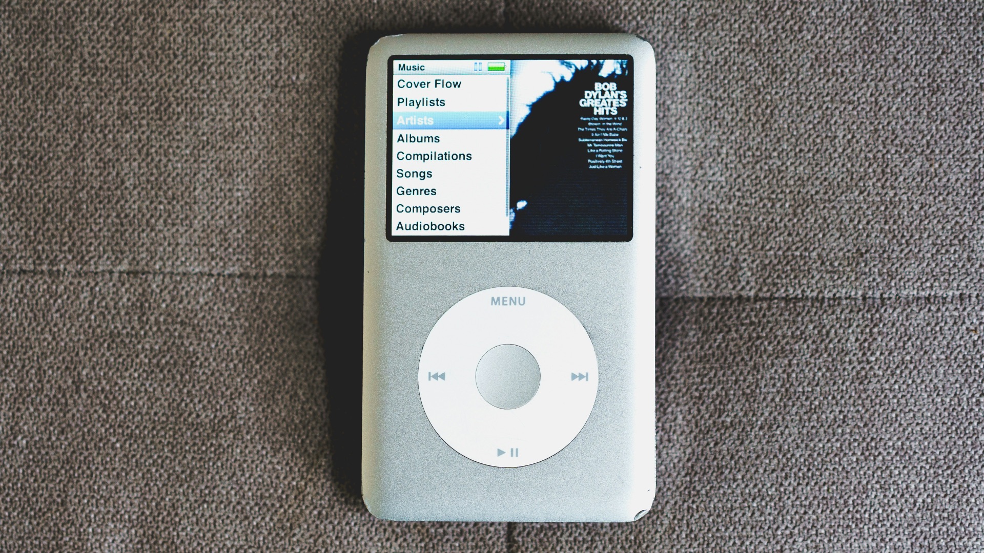an ipod sitting on top of a couch