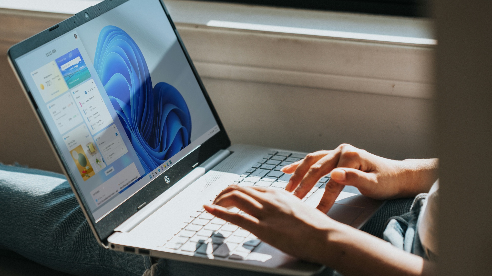 person using Windows 11 computer on lap