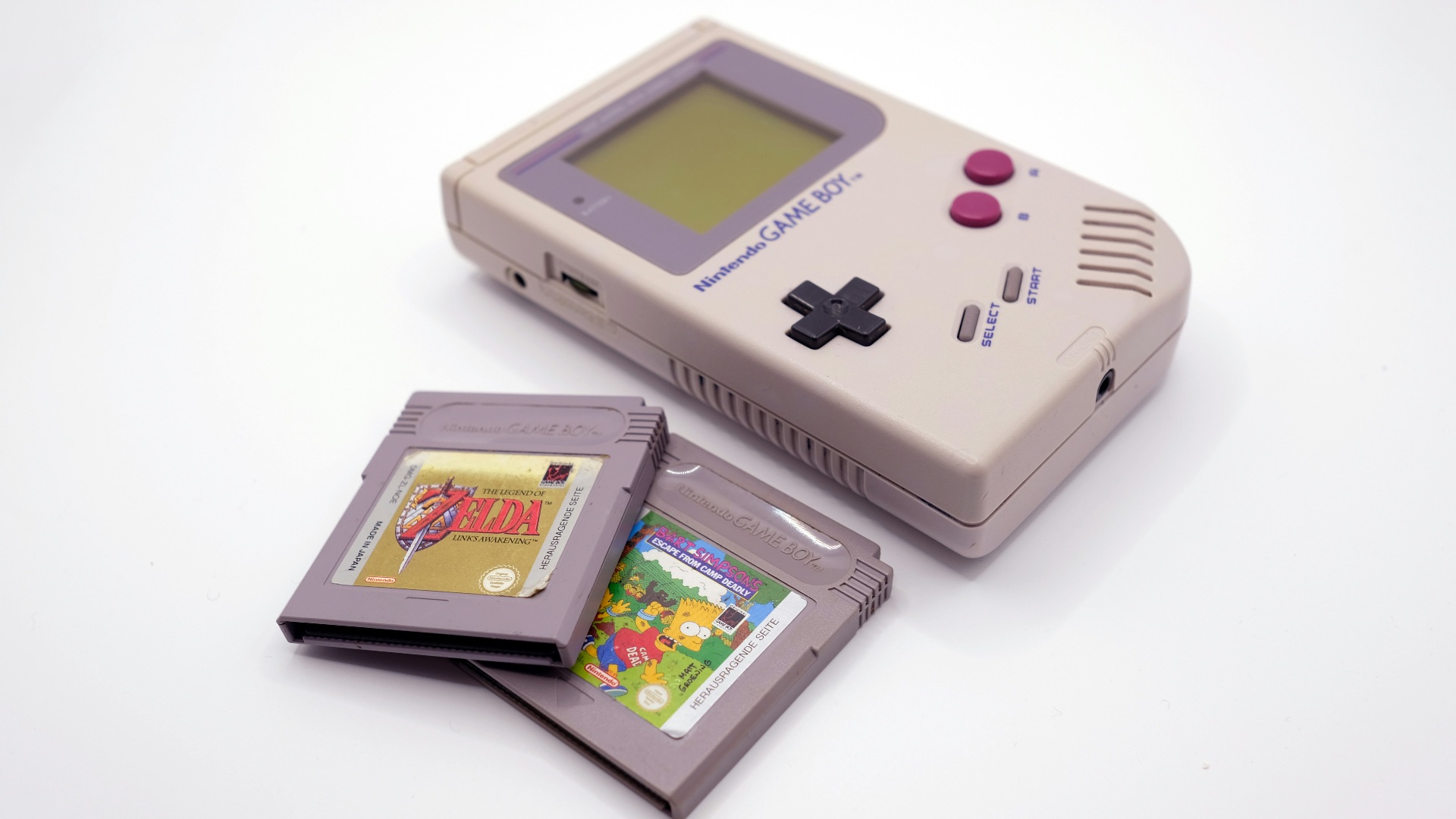 a nintendo game boy with a card and a case