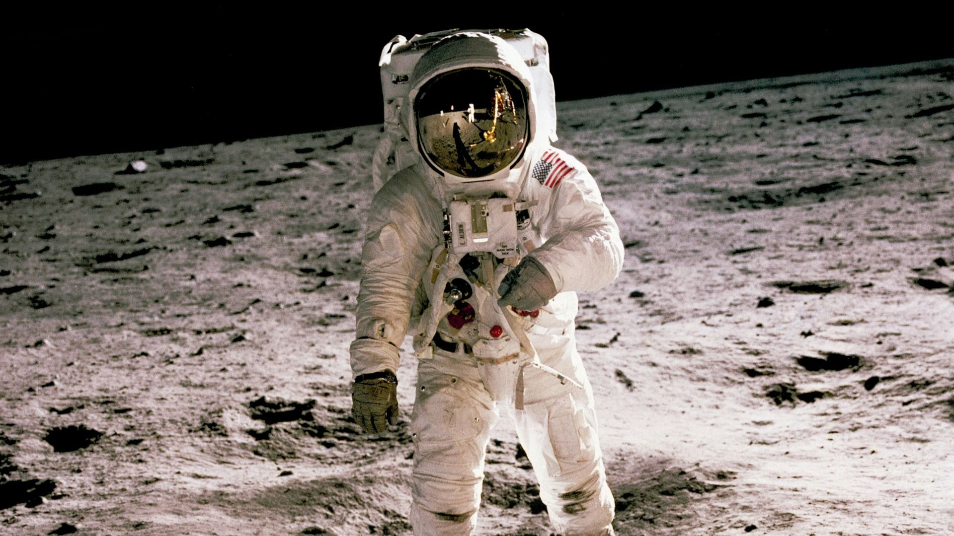 astronaut standing on gray sand