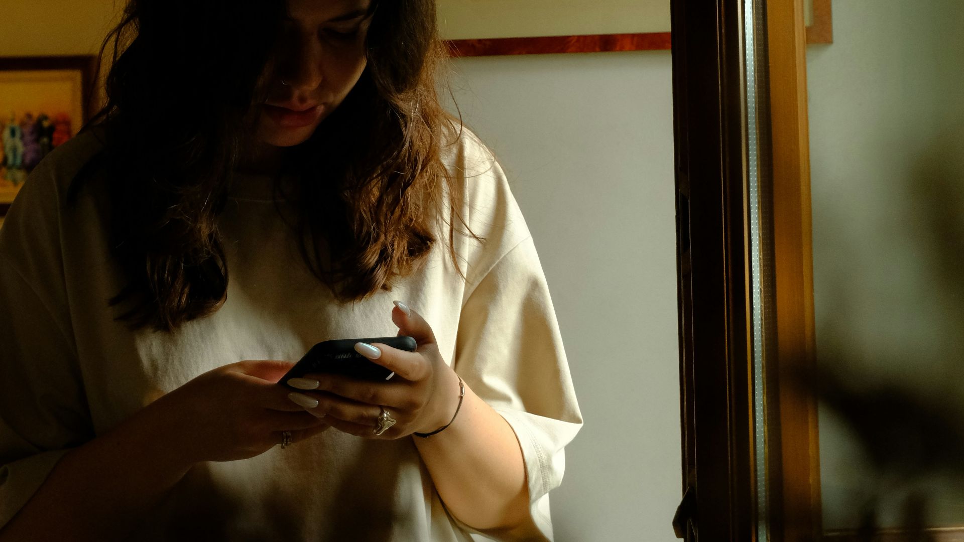 a woman wearing a crown looking at her cell phone