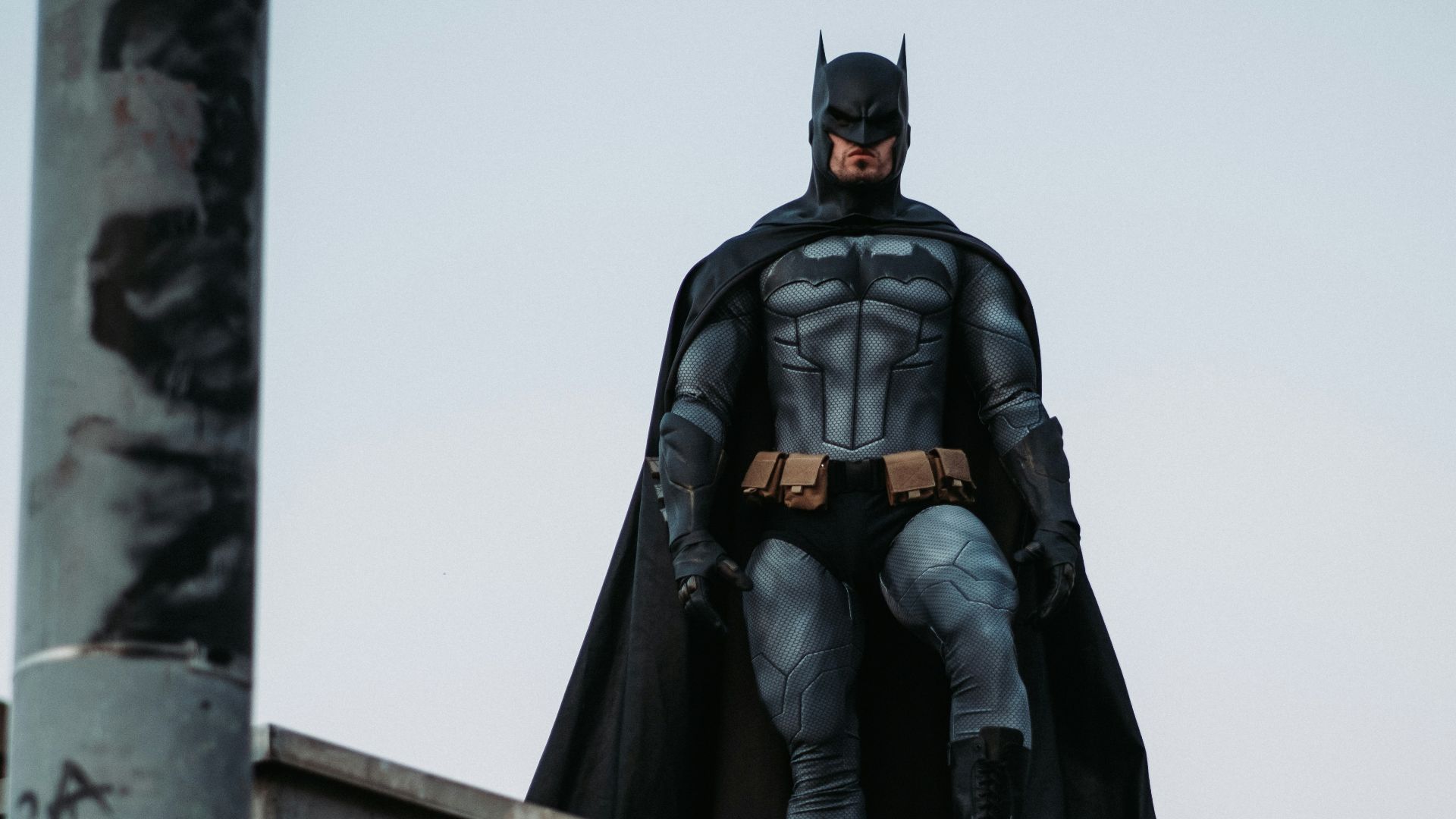 man in black jacket and pants standing on roof