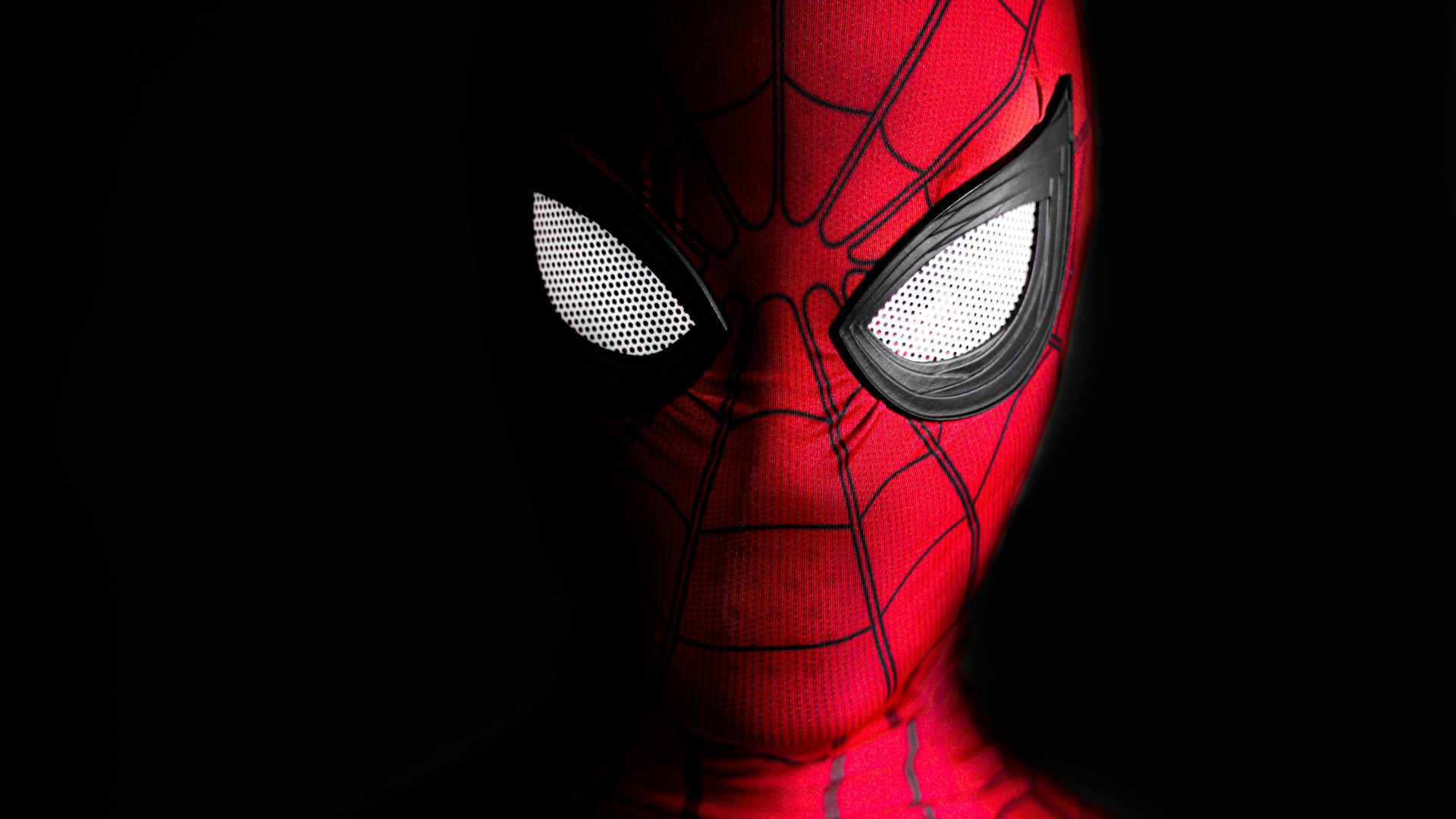 a close up of a spider man with glowing eyes