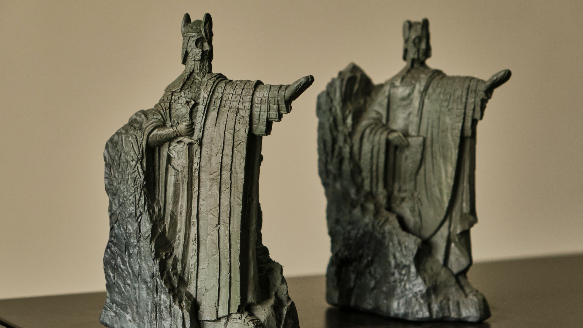 two statues of a man and a woman on a table