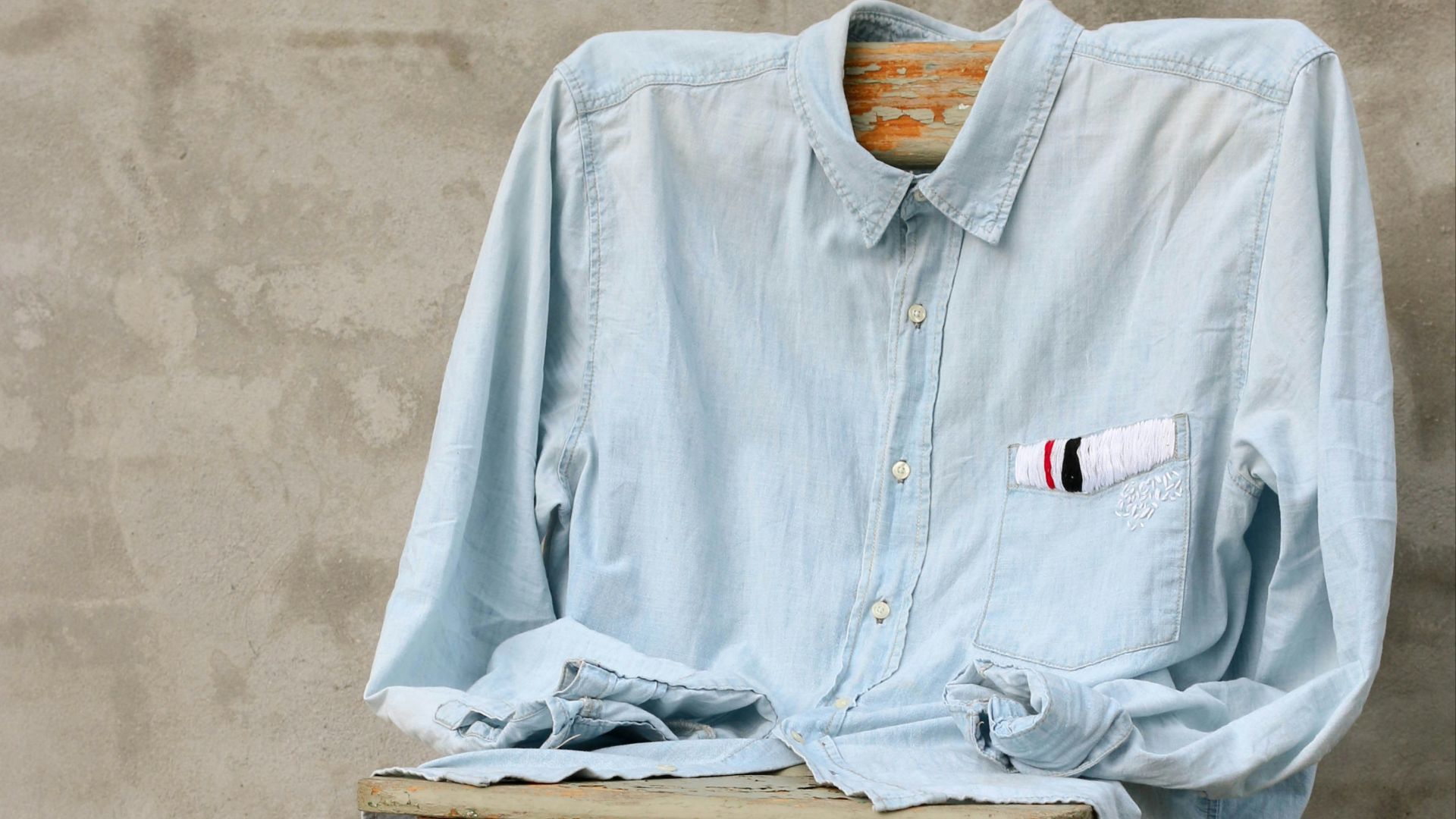 blue dress shirt on chair