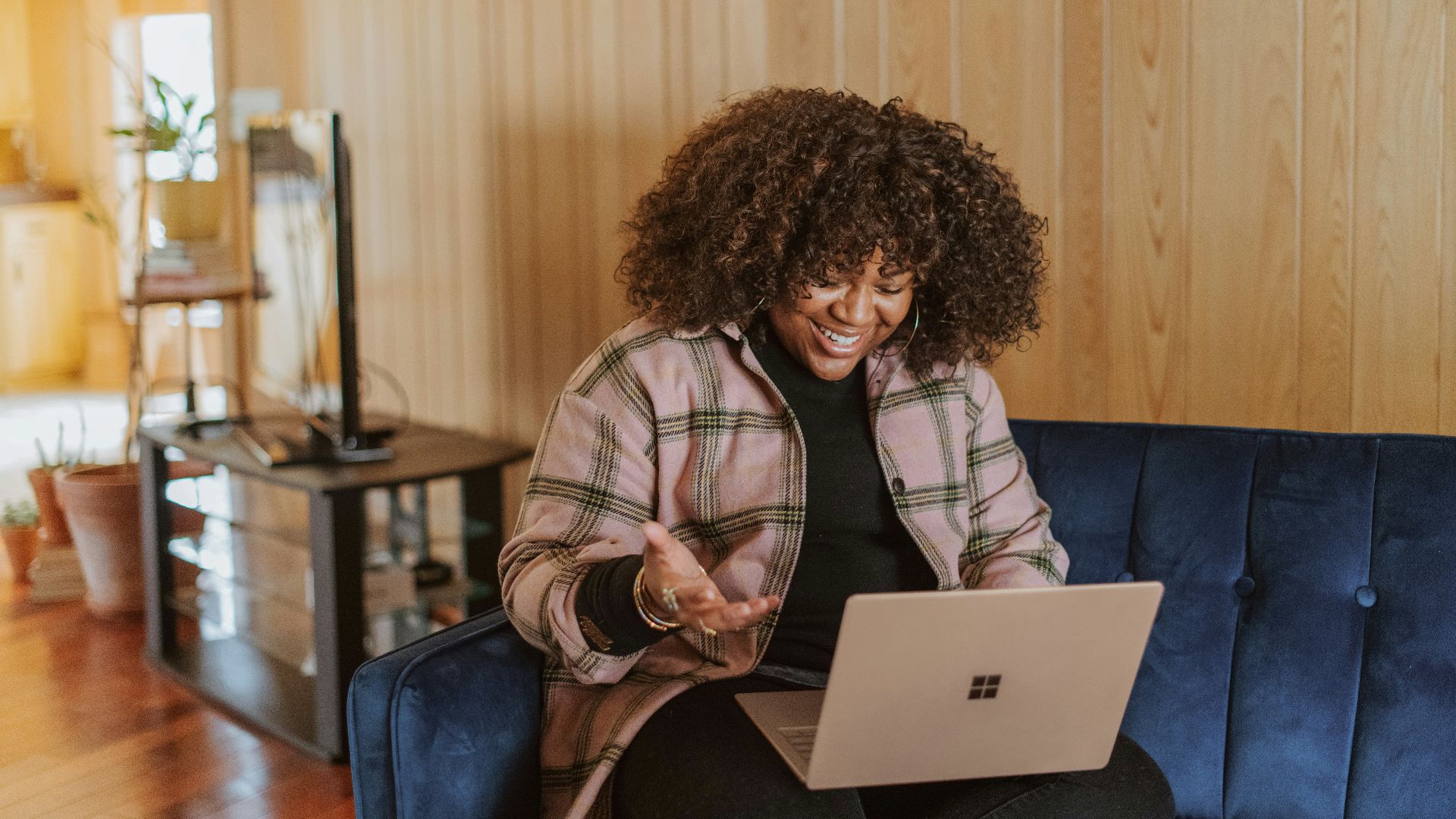 person sitting on couch holding a Surface device