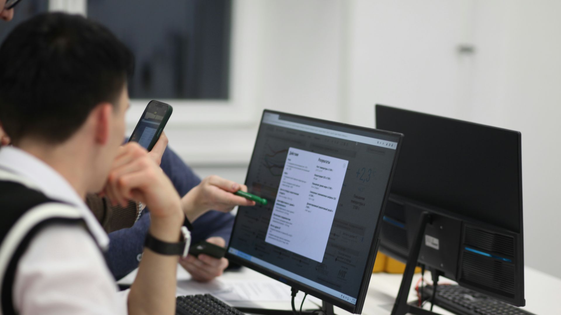 A group of people sitting at a table with computers