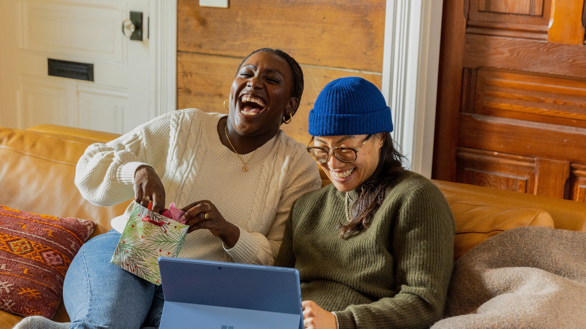 a person sitting on a couch with a laptop