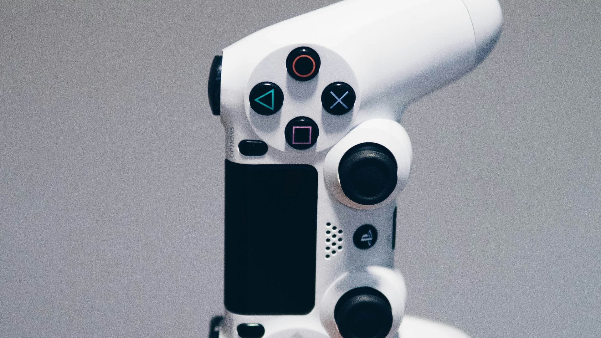 white Sony PS4 DualShock controller over person's palm