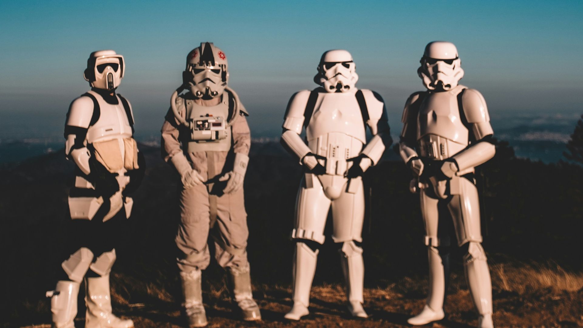 four person wearing Star Wars Clone Trooper costumes