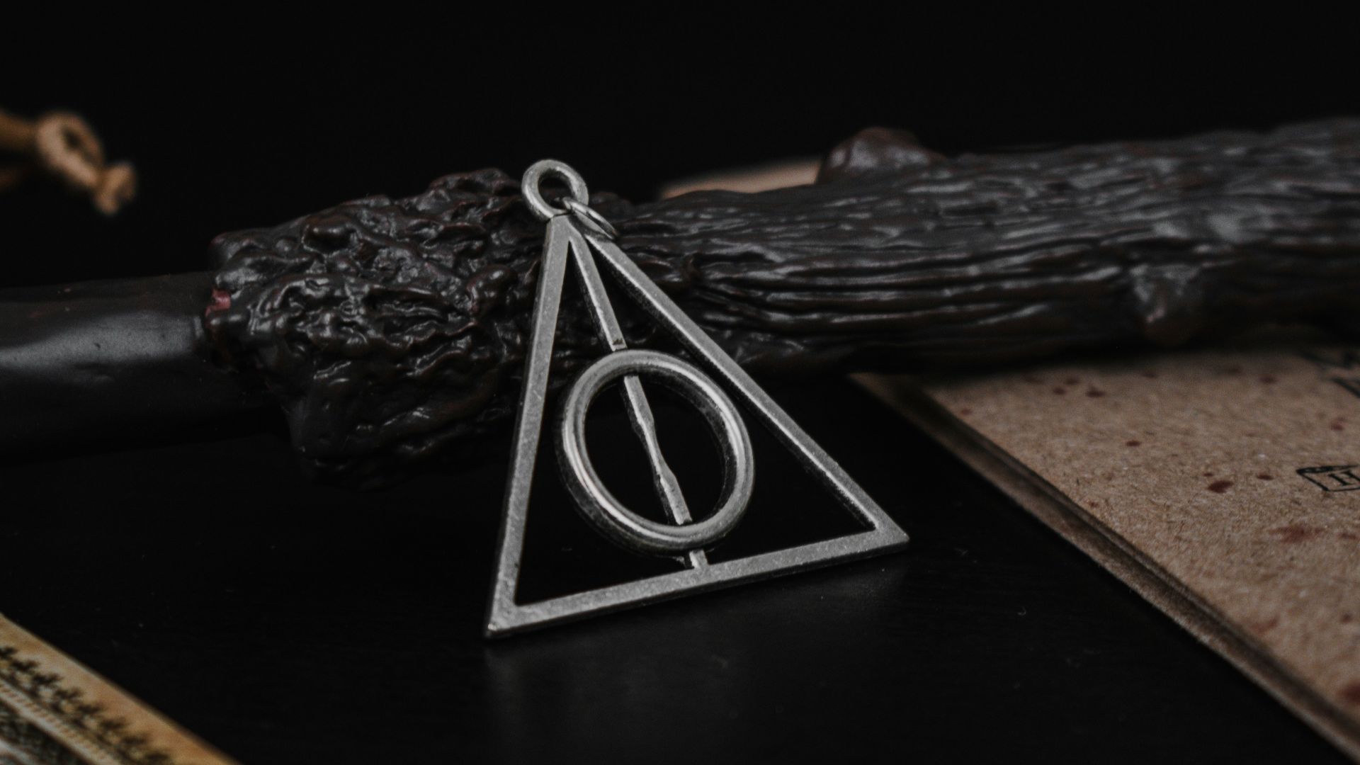 a harry potter necklace sitting on top of a table