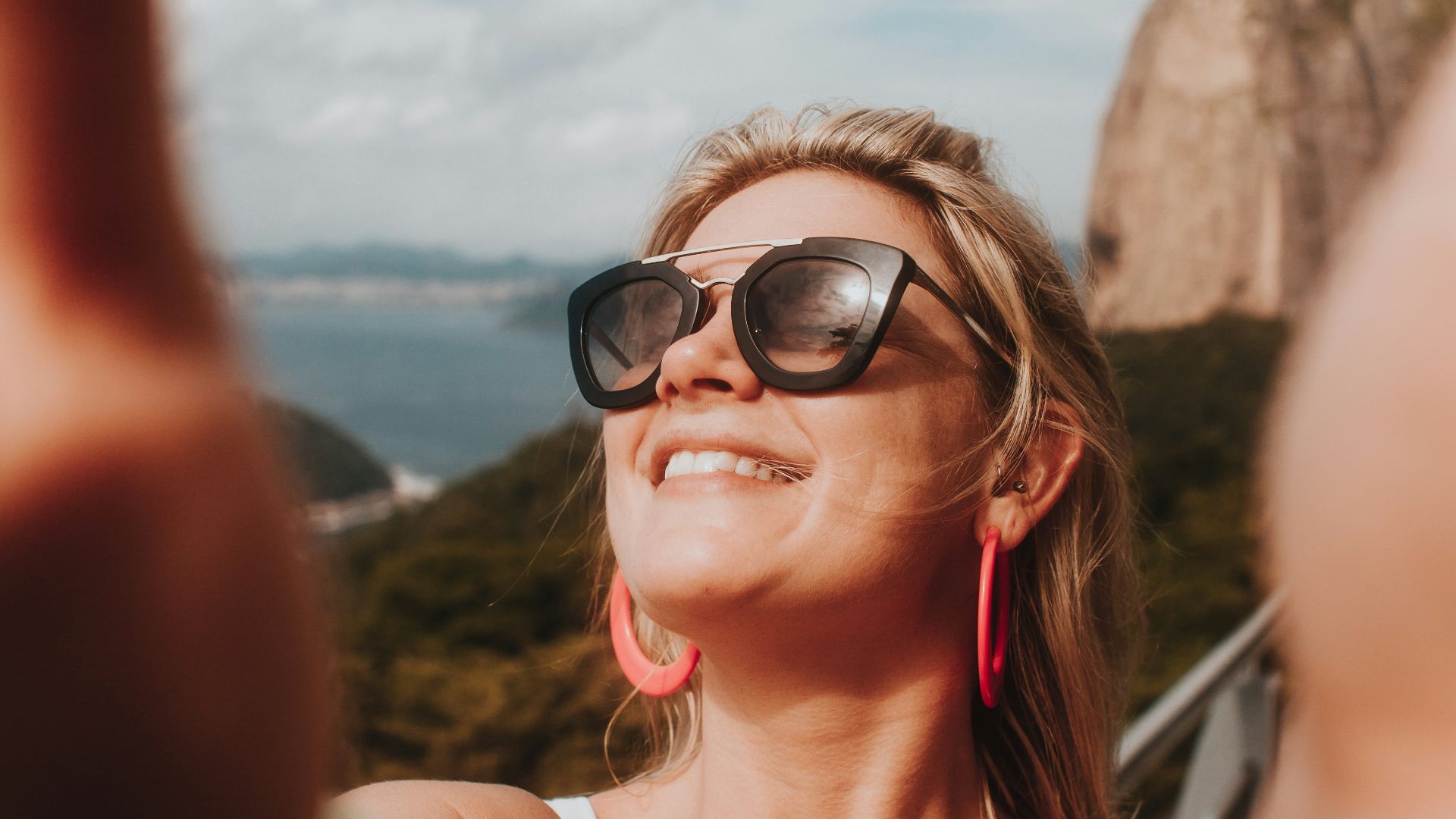 woman in white tank top wearing black sunglasses