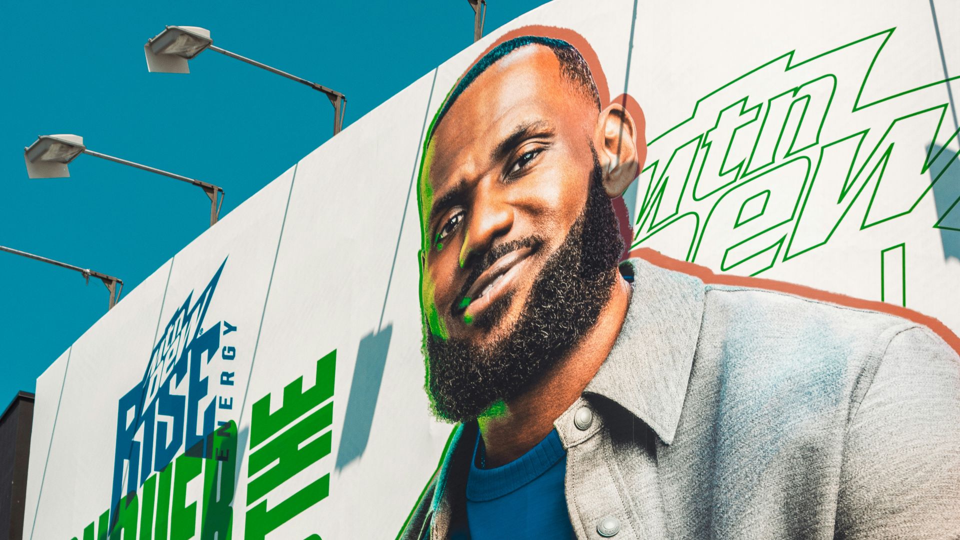 Lebron james holding a rise energy drink can.