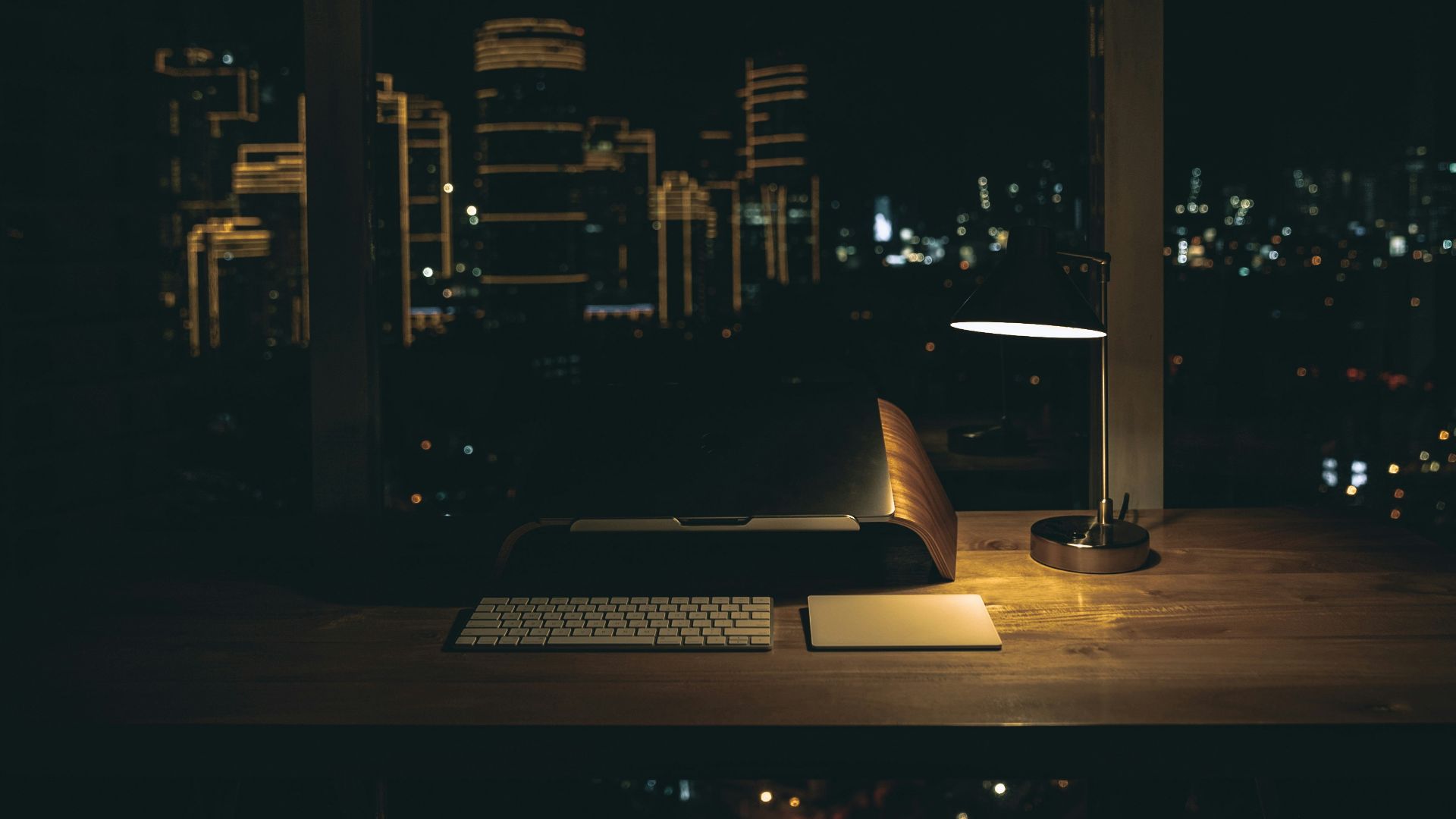lit desk lamp on top of desk