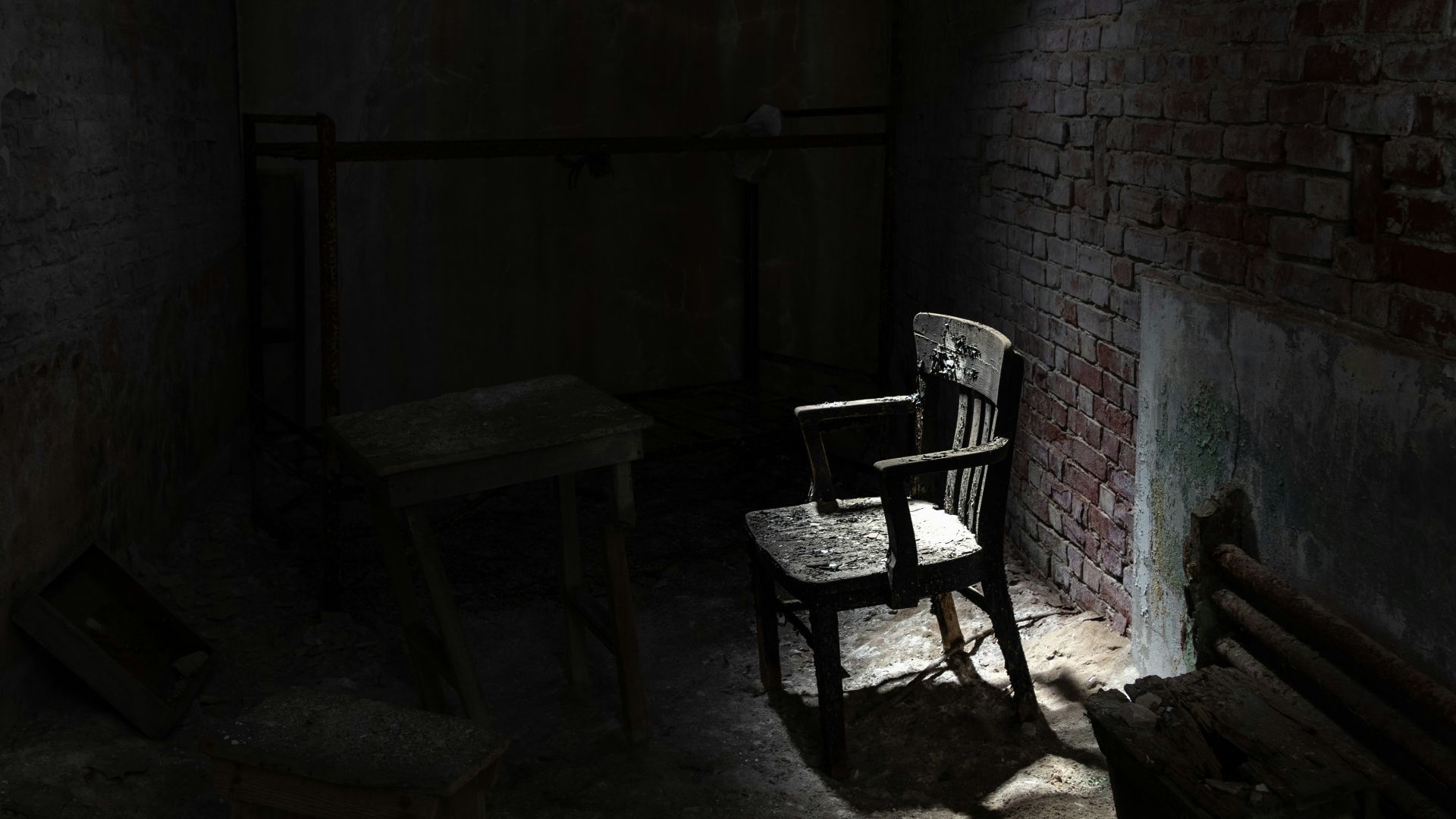 grayscale armchair near wall