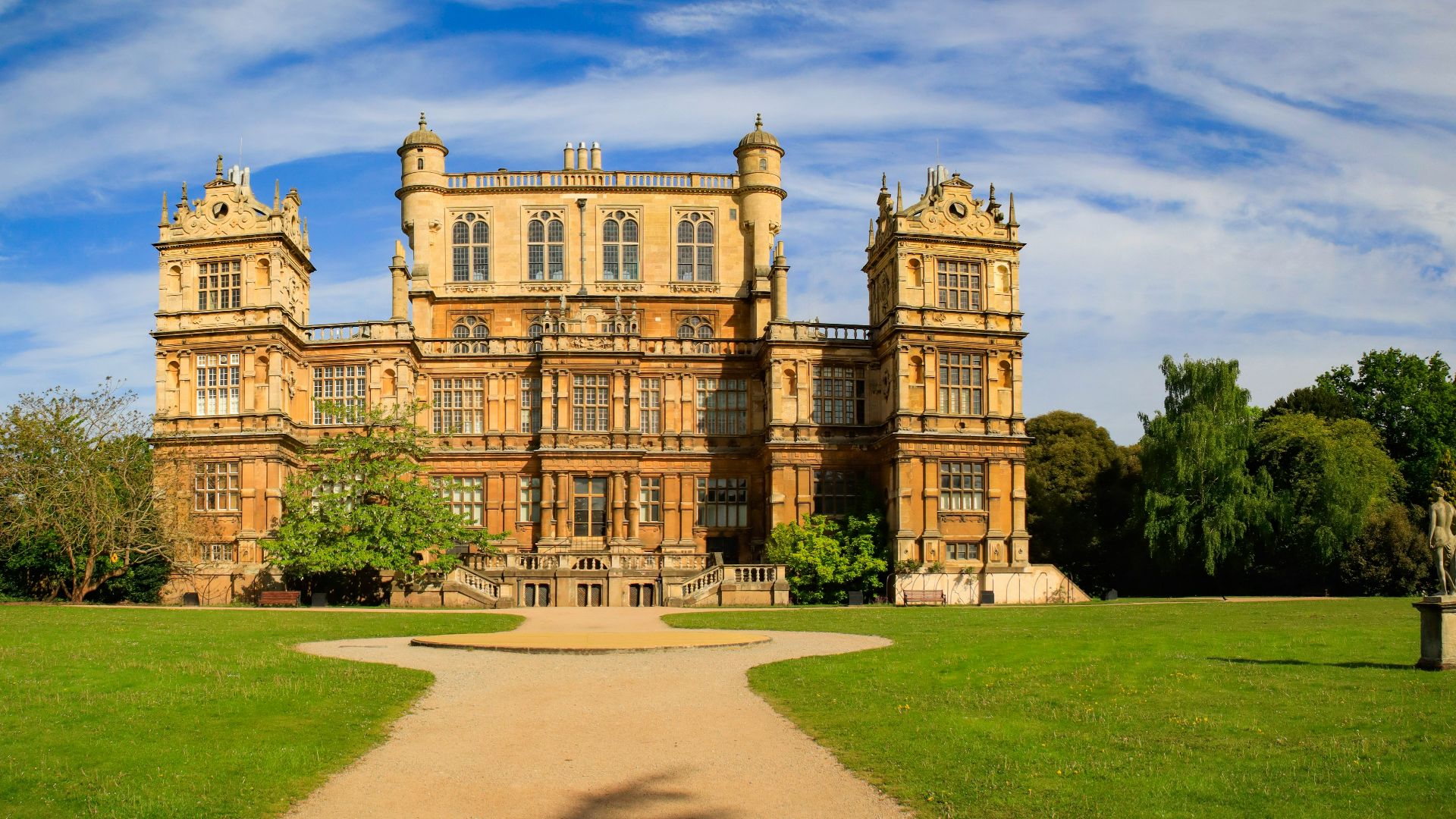 a large building sitting on top of a lush green field