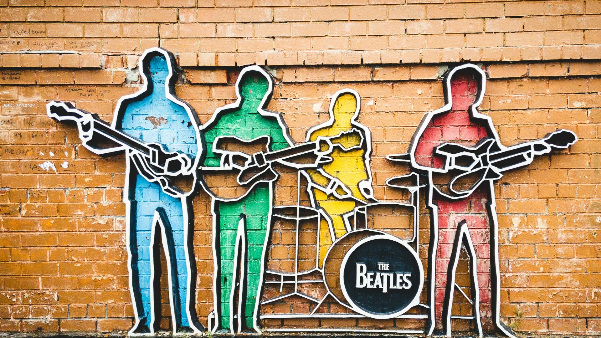 man in blue shirt and black pants standing on brown wooden ladder