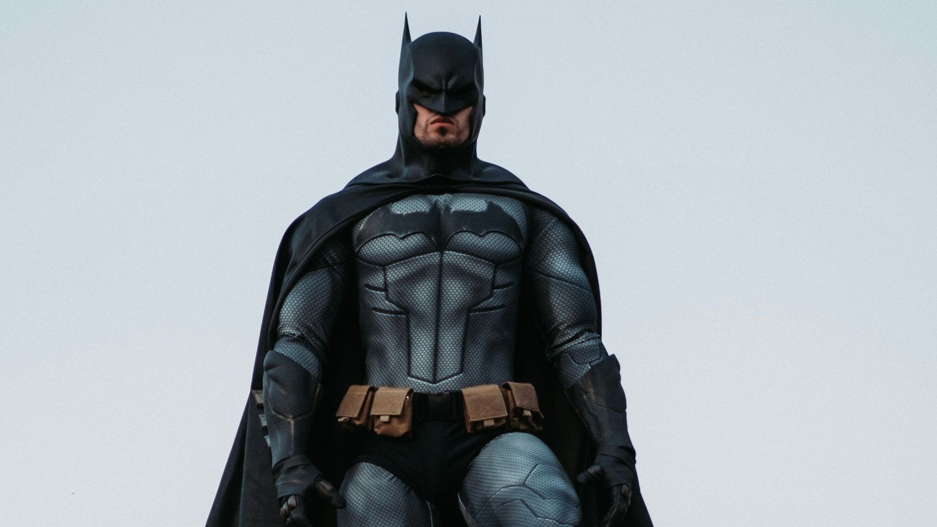 man in black jacket and pants standing on roof