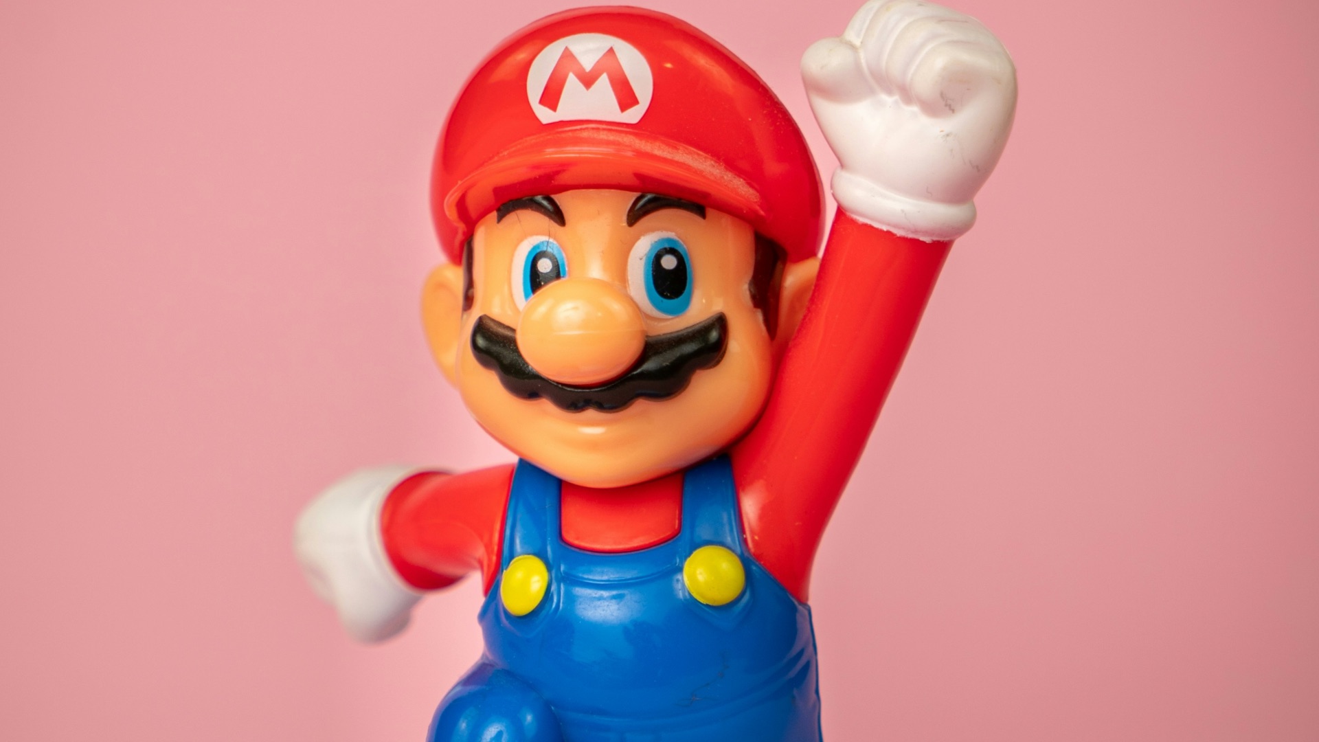 a toy figure of mario on top of a blue object