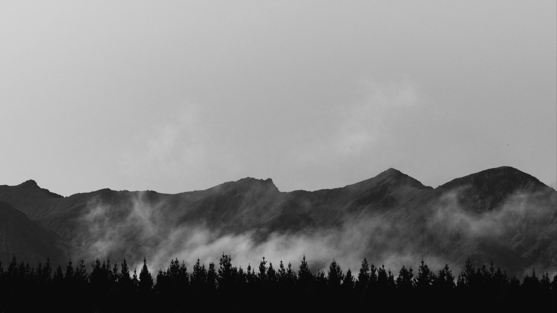 a black and white photo of a mountain range