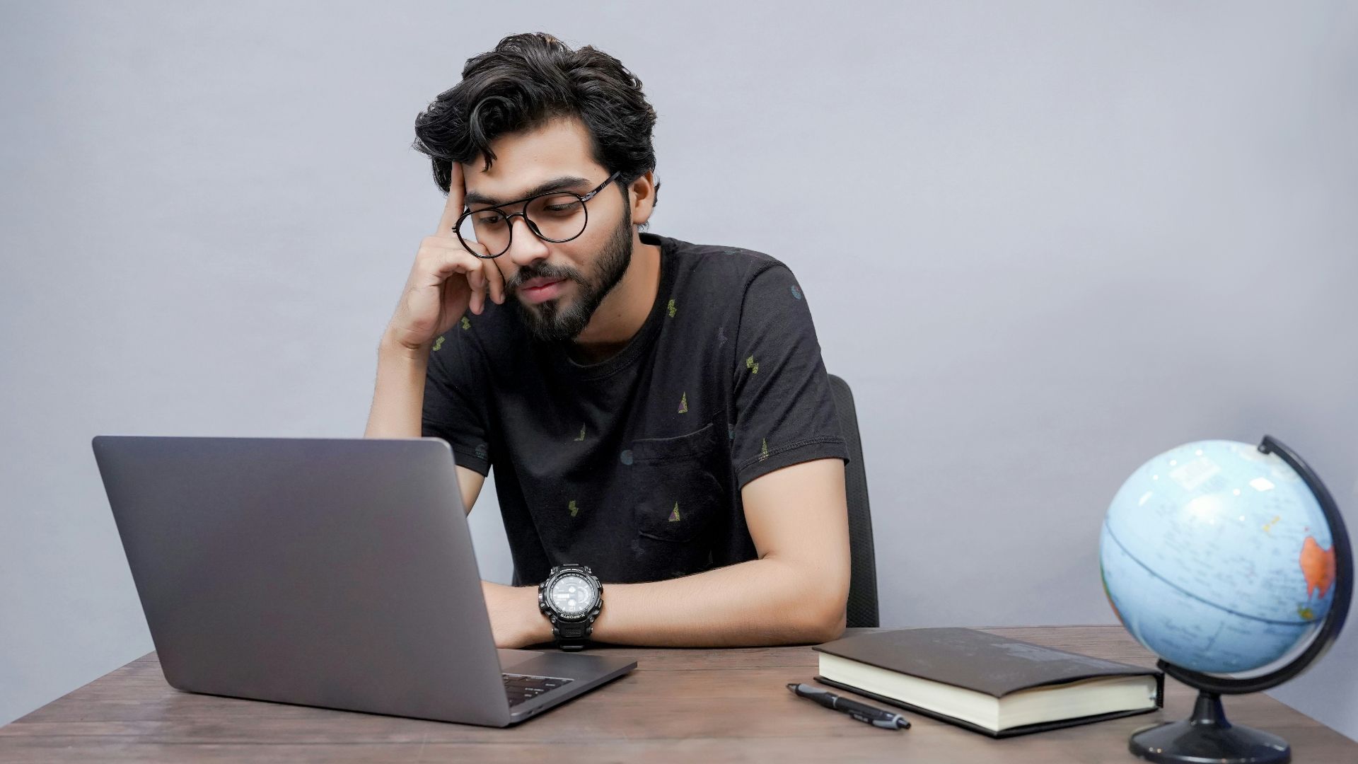 a man sitting in front of a laptop computer