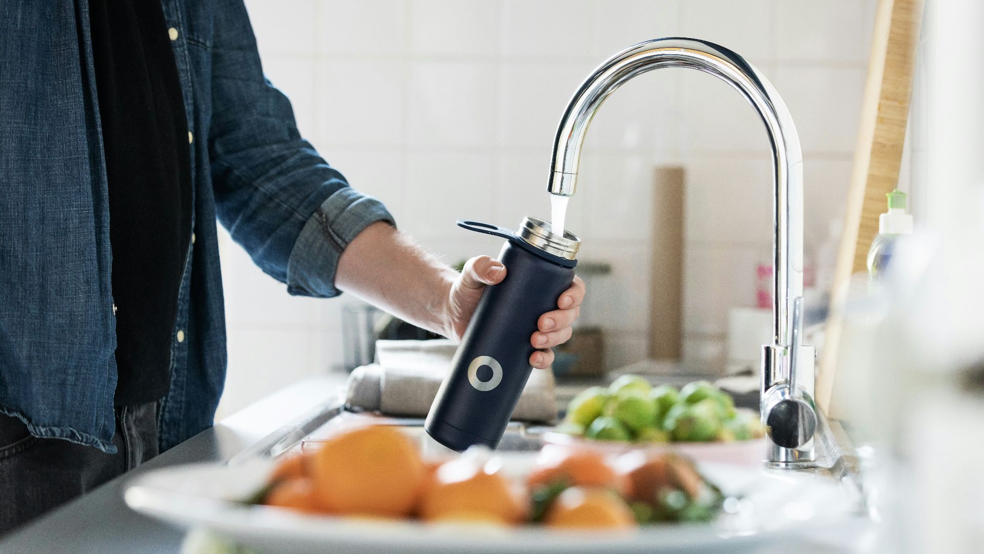 person holding stainless steel faucet