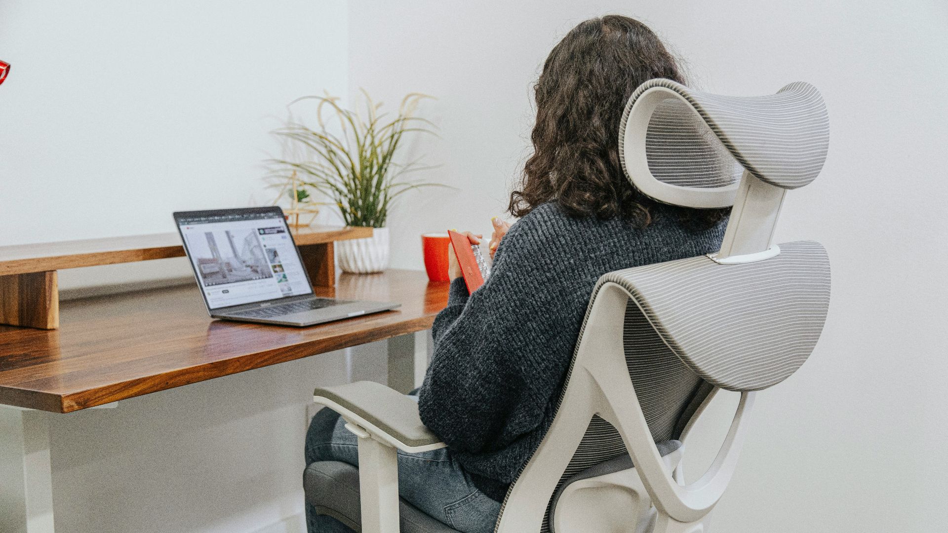 a woman sitting at a desk with a laptop