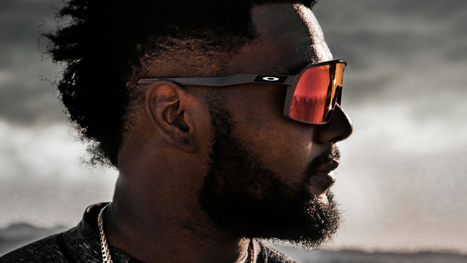 man in black and white crew neck shirt wearing black sunglasses