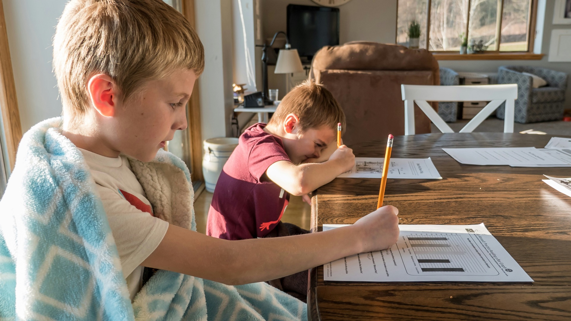 boy in gray crew neck t-shirt reading book