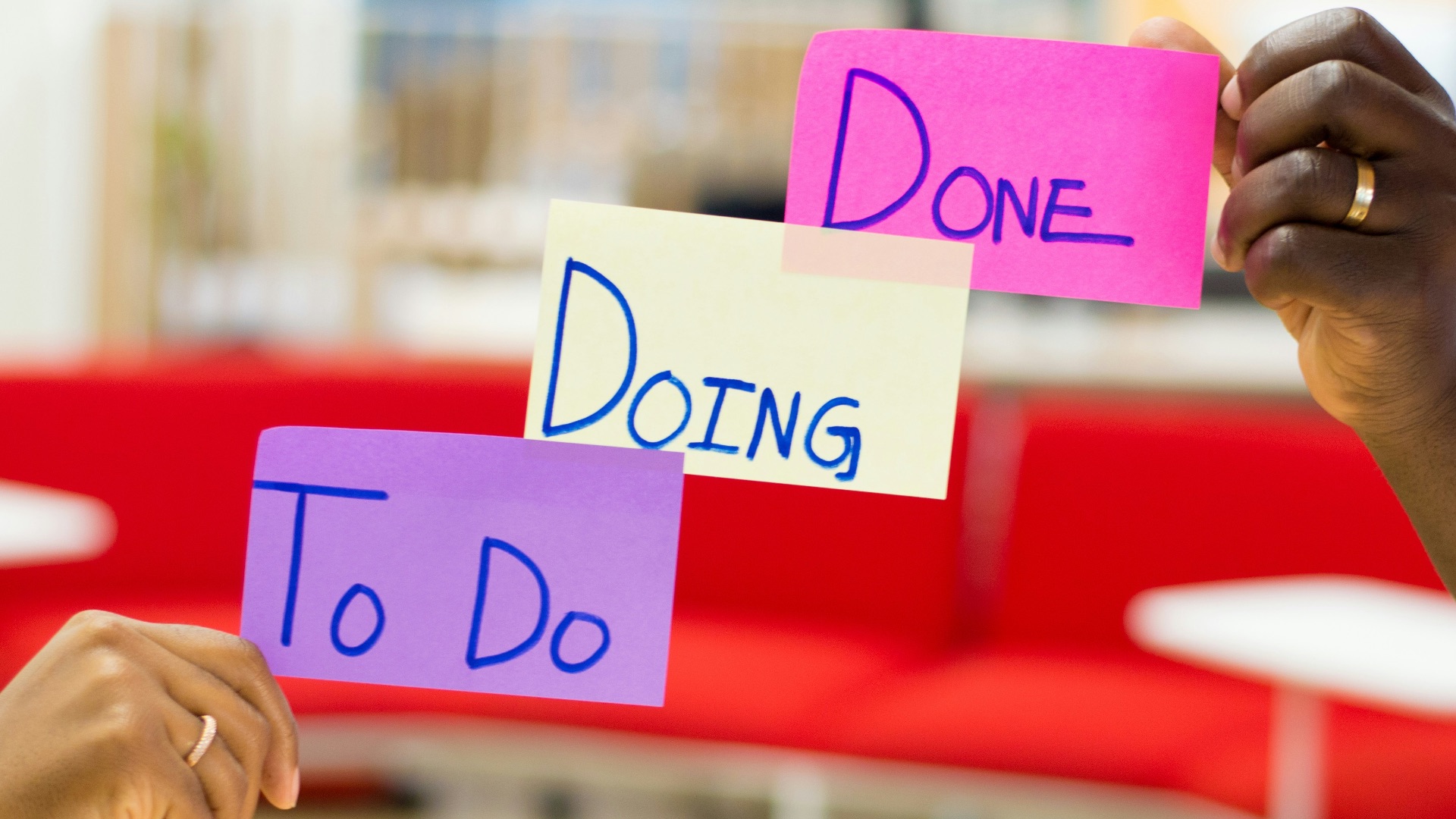 person holding purple and white card