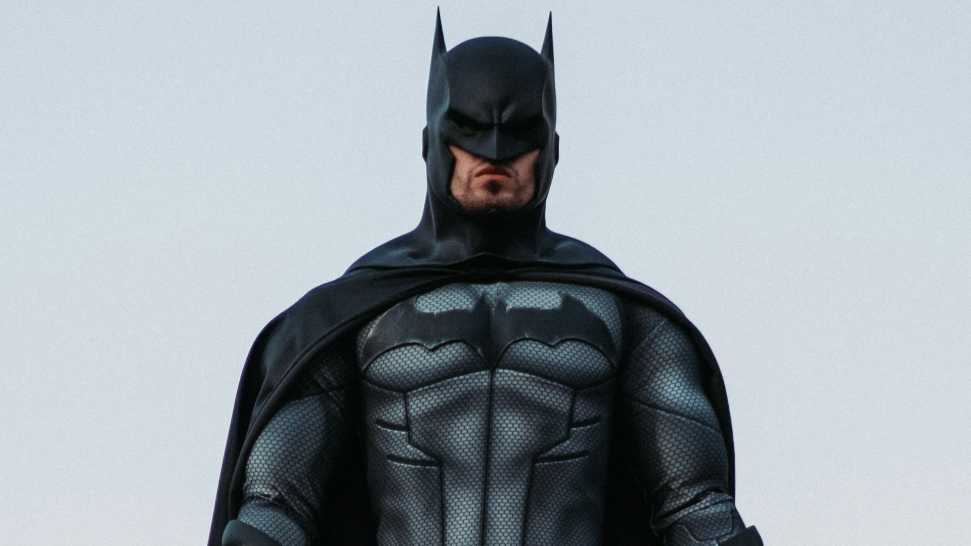 man in black jacket and pants standing on roof