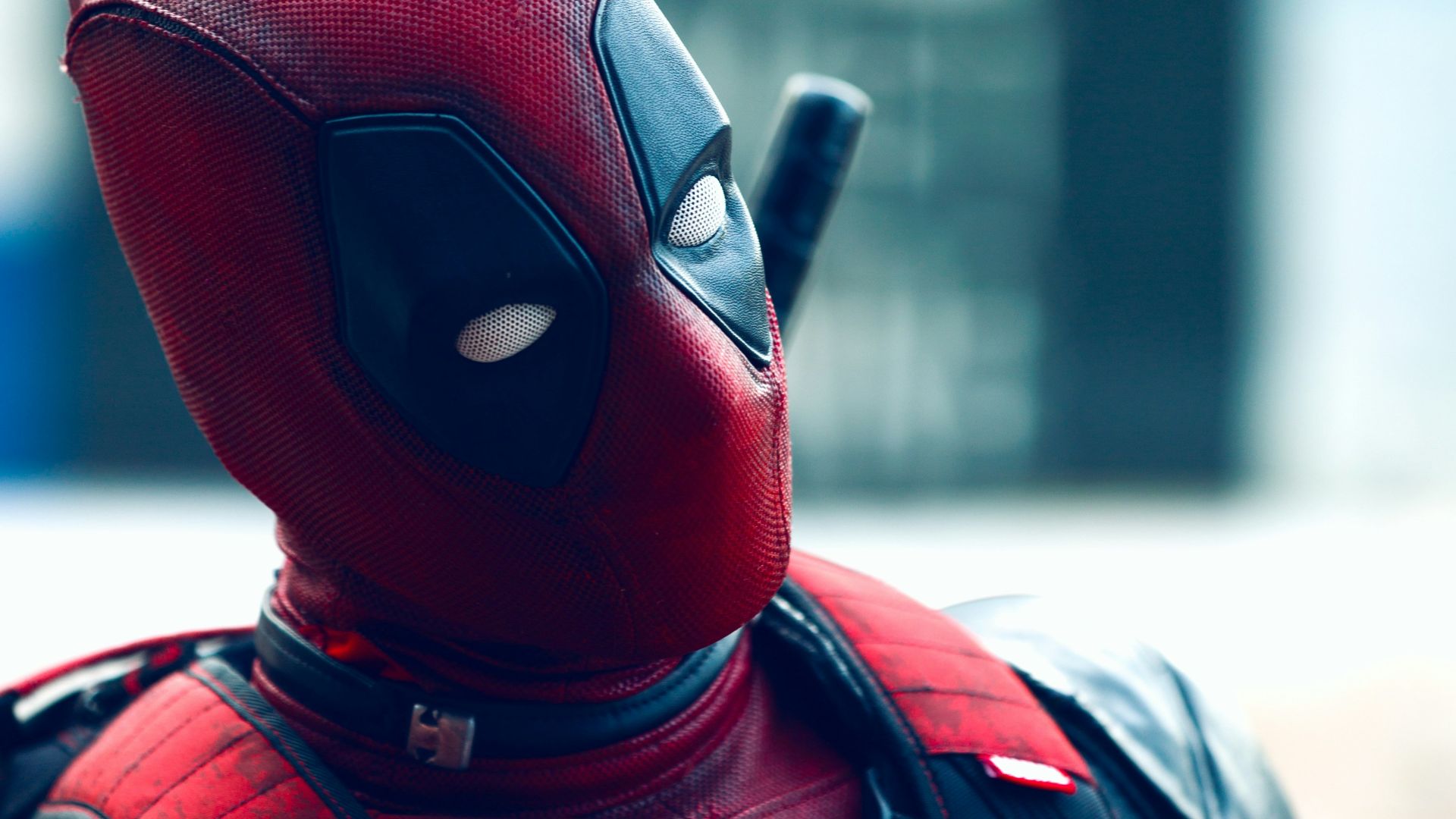 a man in a deadpool costume with a knife in his hand