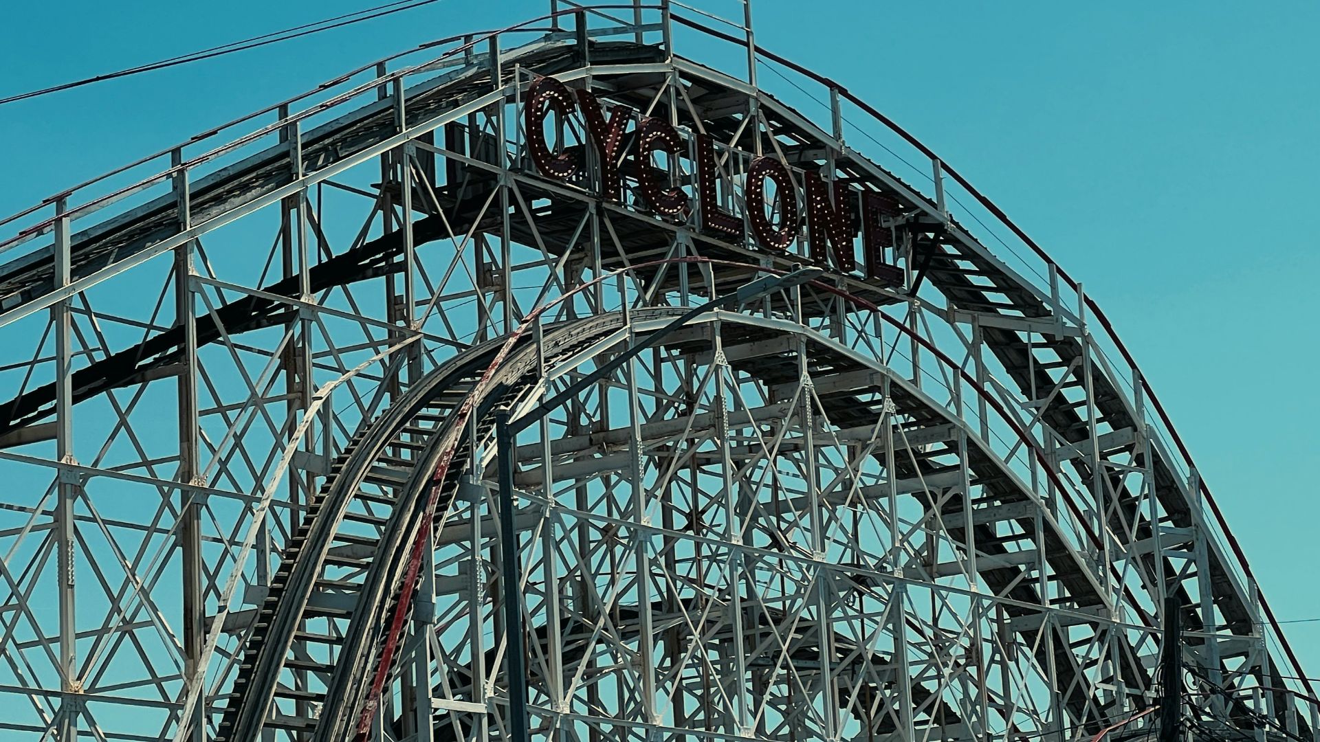 A roller coaster with flags on top of it
