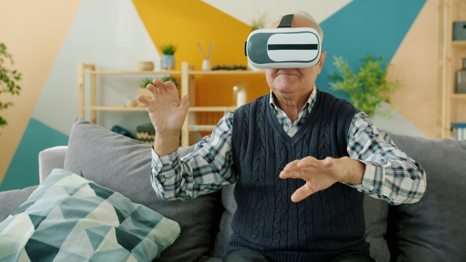 Elderly man using virtual reality headset at home.
