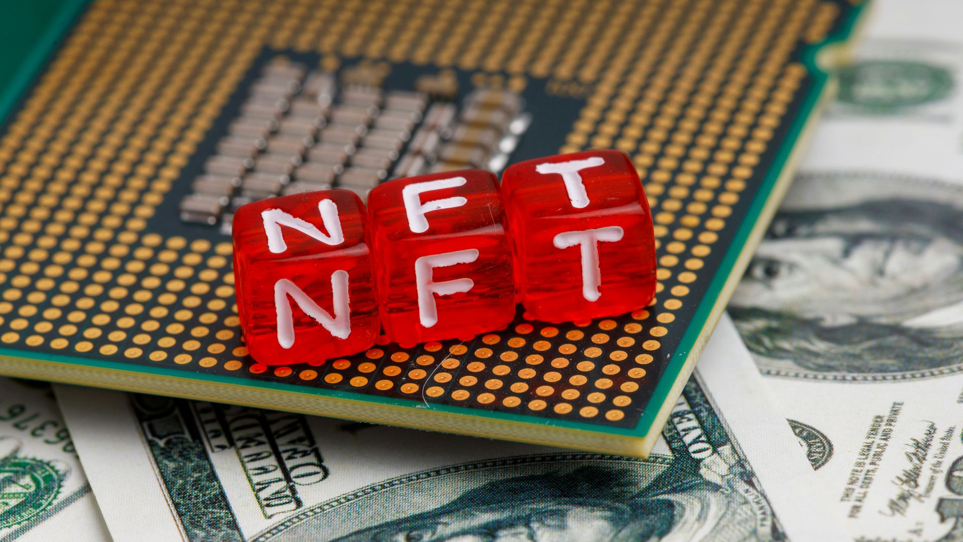 a close up of a small red block on top of a pile of money