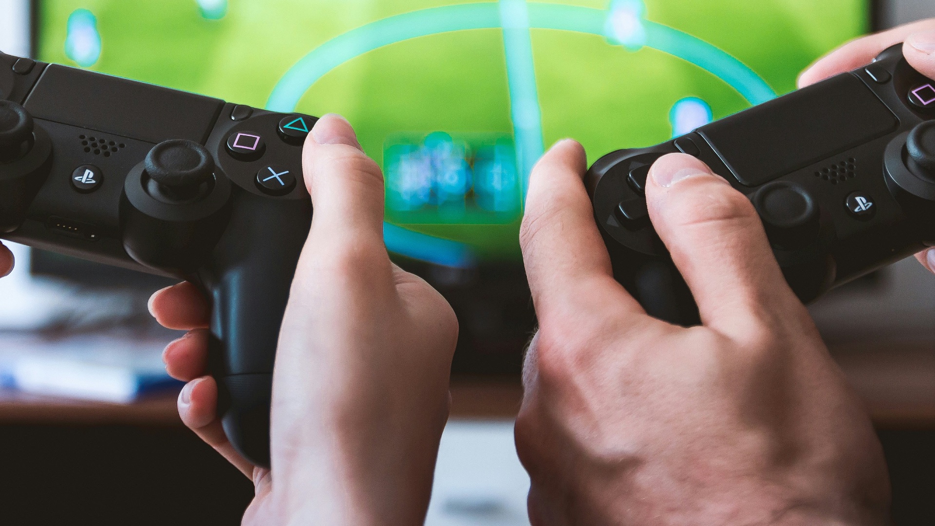 two people playing Sony PS4 game console