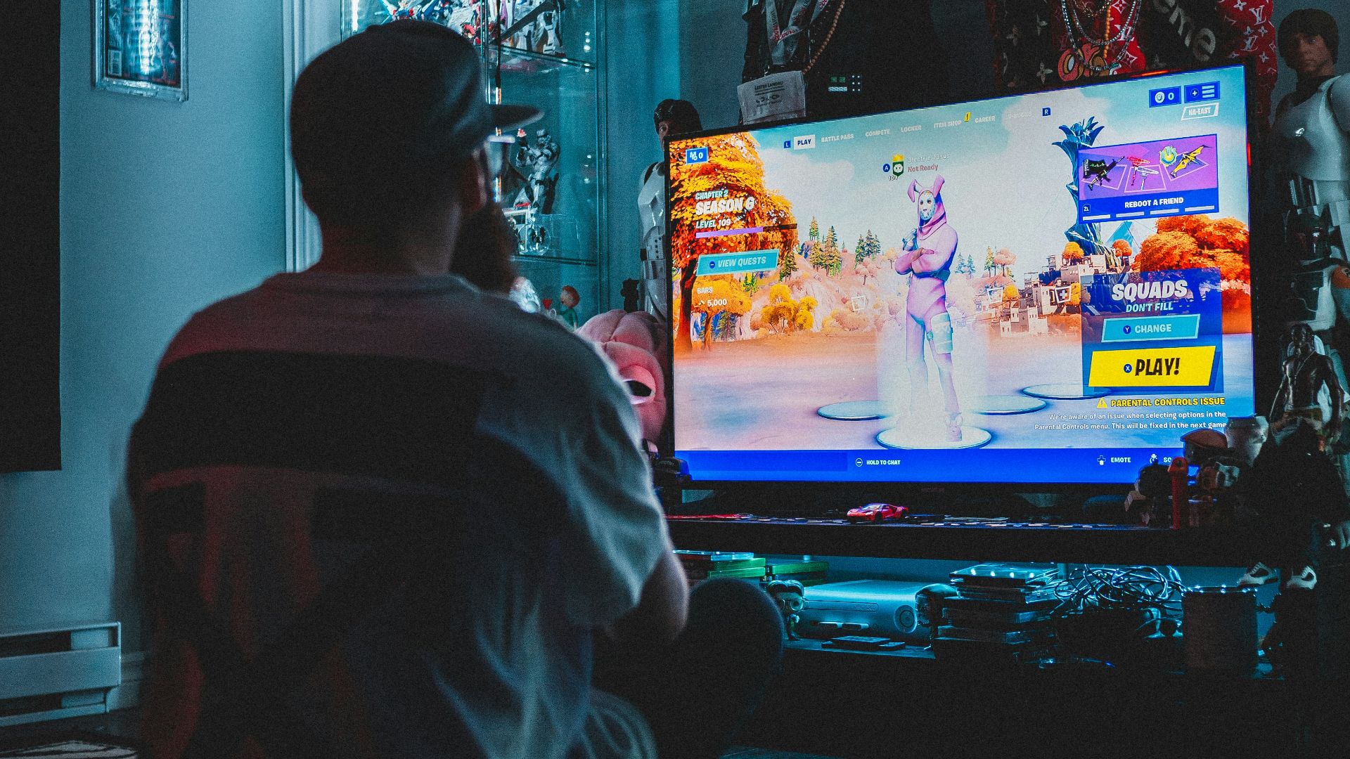 man in red shirt watching tv