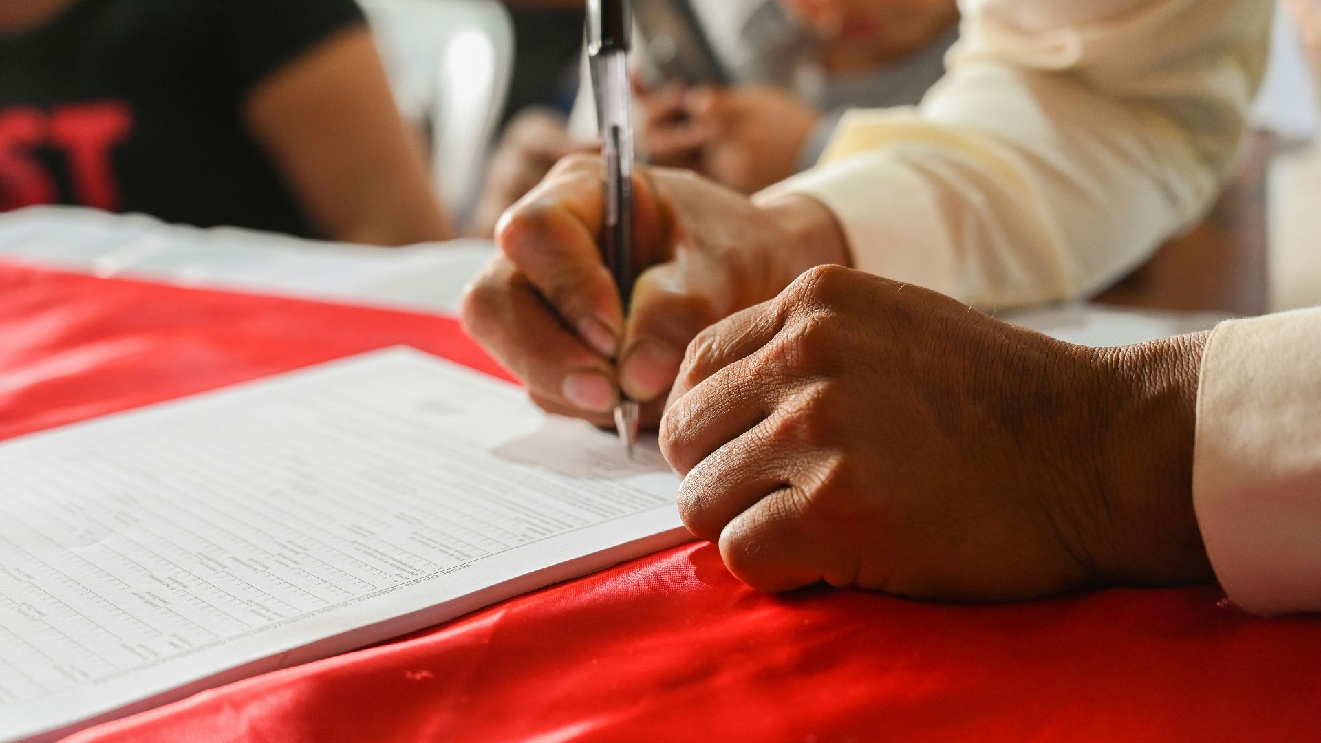 a person writing on a piece of paper