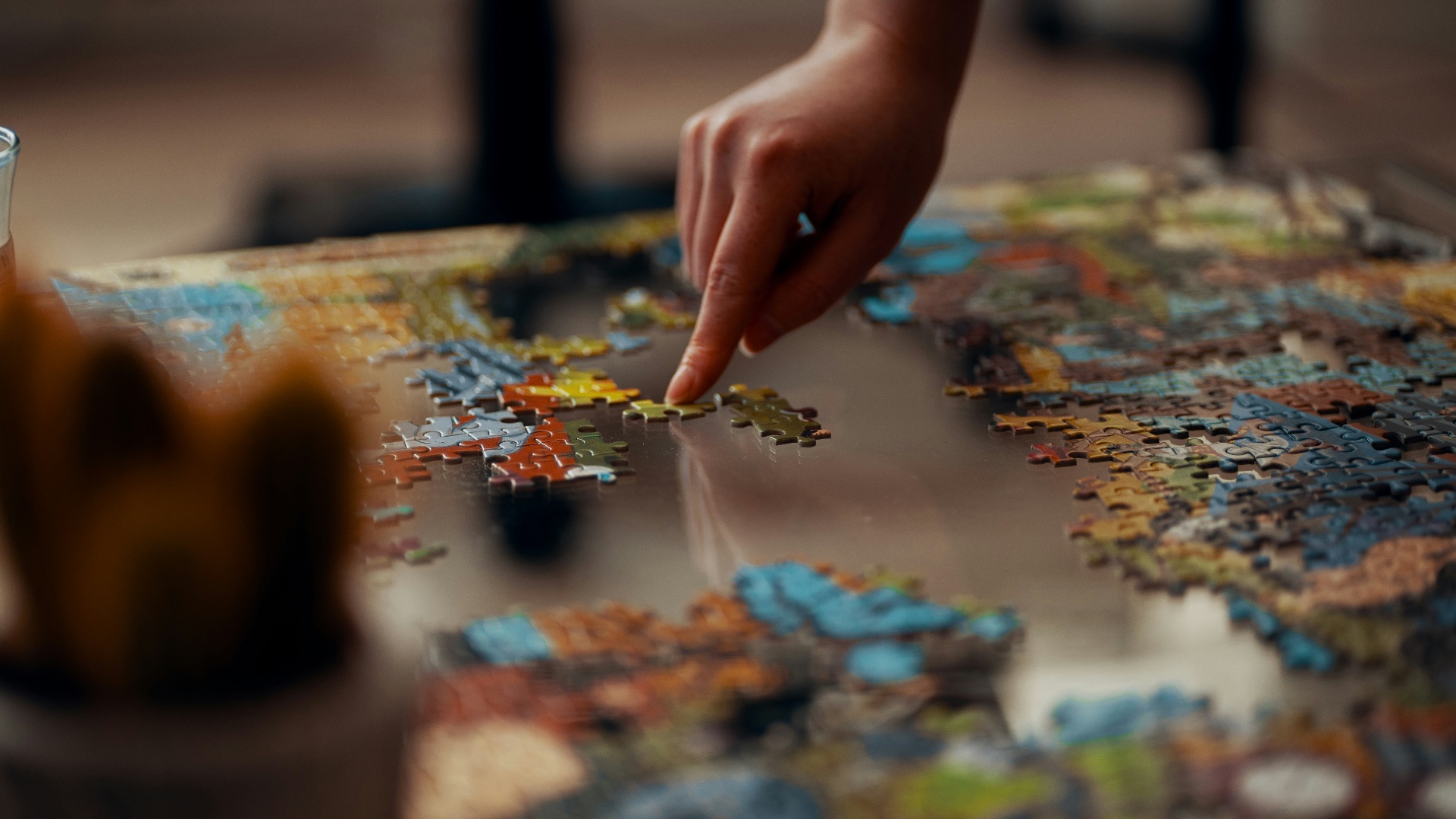 person holding jigsaw puzzle piece