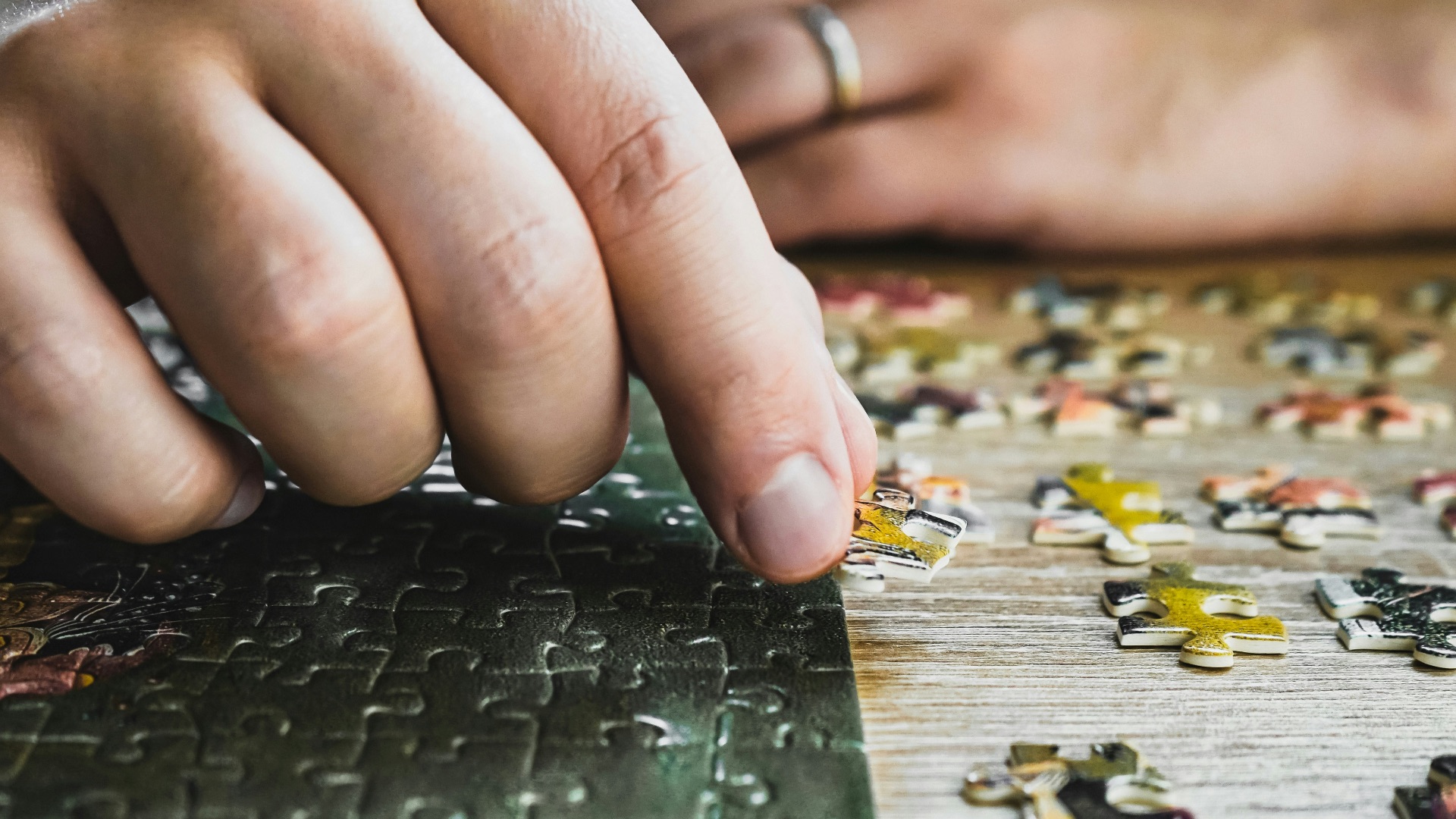 a close up of a person's hand on a puzzle
