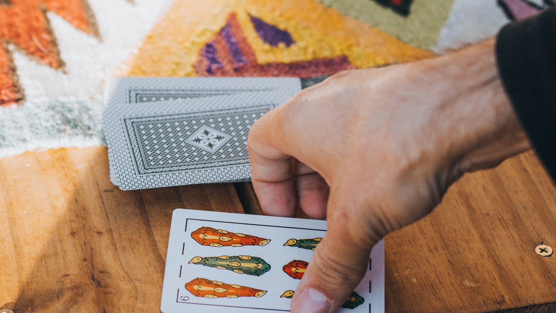 person holding 6 of spades playing card