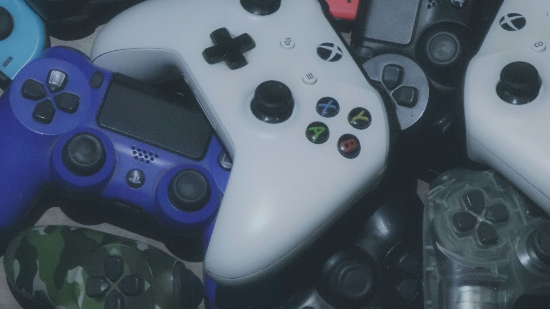 assorted-colored Xbox and Sony Playstaion game controller lot