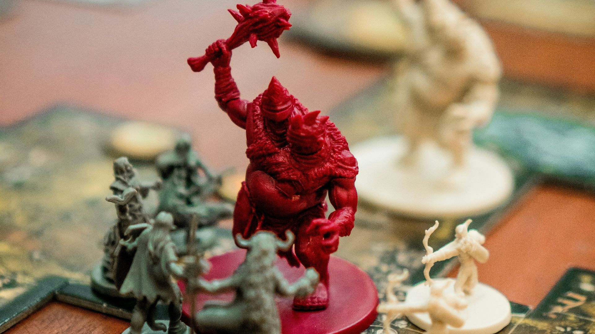 red, white, and green action figures on table