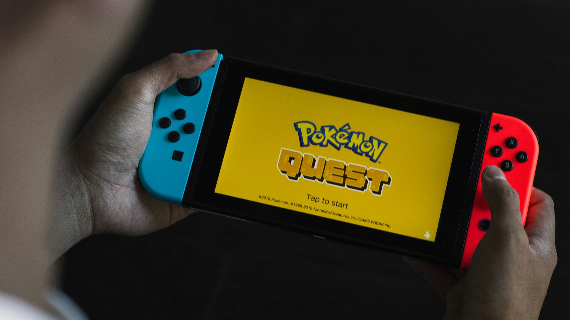 person holding yellow and blue box